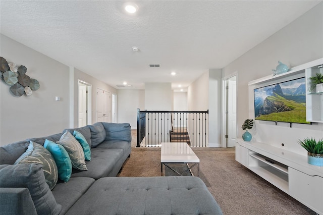 carpeted living room with a textured ceiling