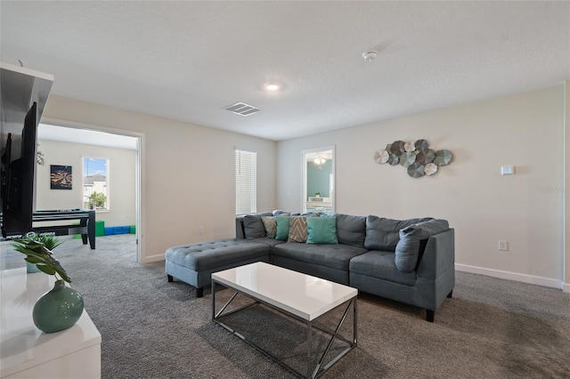 carpeted living room with a textured ceiling