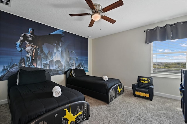 carpeted bedroom with a textured ceiling and ceiling fan