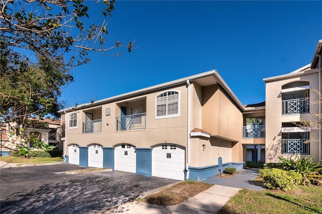 view of front of home with a balcony and a garage