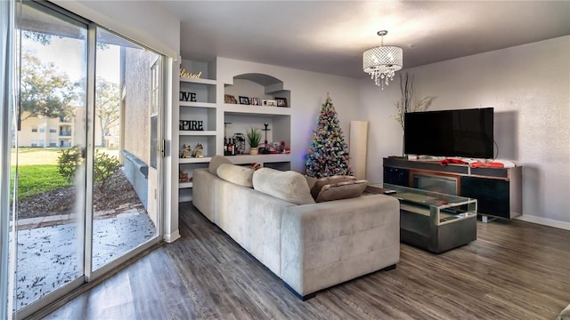 living room featuring dark hardwood / wood-style flooring and an inviting chandelier