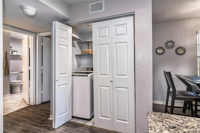 kitchen with hardwood / wood-style floors and washer / dryer