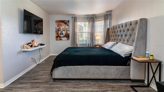 bedroom with dark wood-type flooring