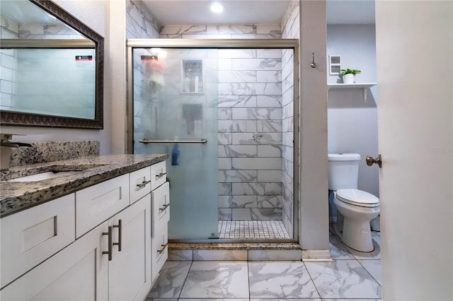 bathroom with vanity, toilet, and walk in shower