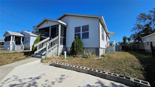 view of front of home featuring a sunroom