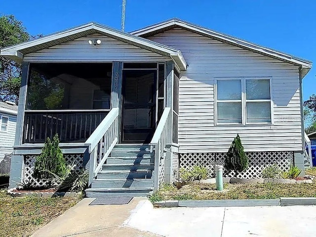 view of front of home featuring a sunroom