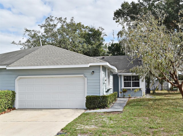 ranch-style home featuring a front lawn and a garage