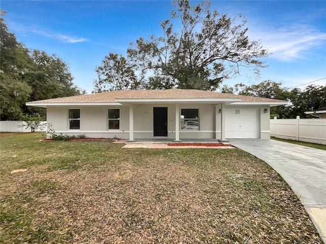 ranch-style home with a front yard, a porch, and a garage