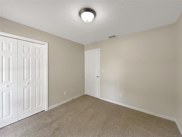 unfurnished bedroom featuring a closet and carpet floors