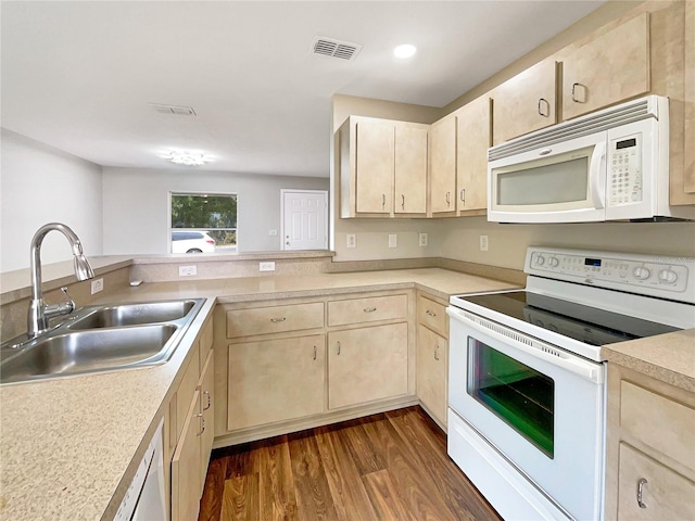 kitchen featuring sink, dark hardwood / wood-style floors, kitchen peninsula, white appliances, and light brown cabinetry