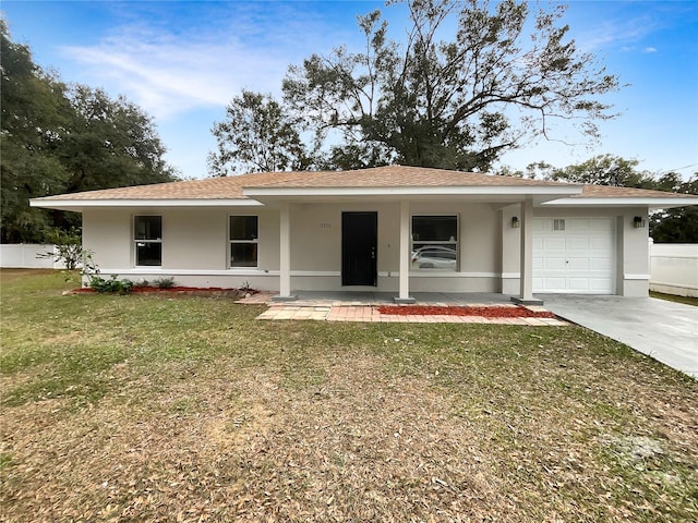 ranch-style home featuring covered porch, a front yard, and a garage