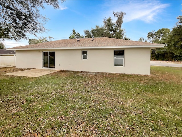 rear view of house with a patio area and a yard