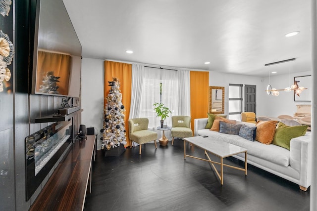 living room featuring dark hardwood / wood-style floors and an inviting chandelier