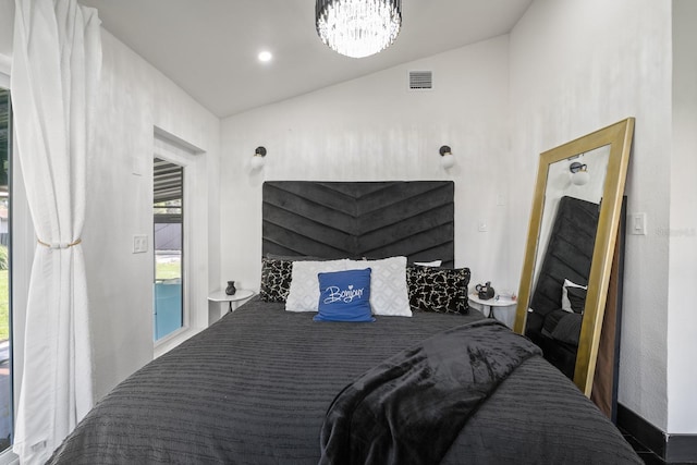 bedroom with vaulted ceiling and a notable chandelier