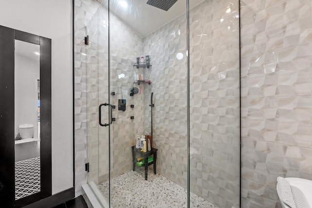 bathroom featuring a shower with shower door