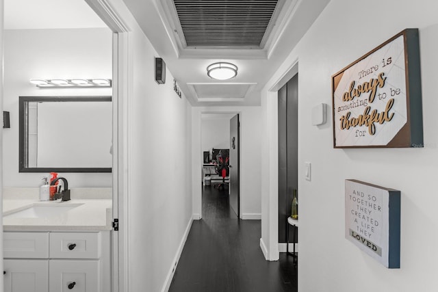 hallway featuring sink and dark wood-type flooring