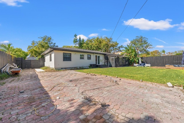 back of house with a lawn, a patio area, and central air condition unit