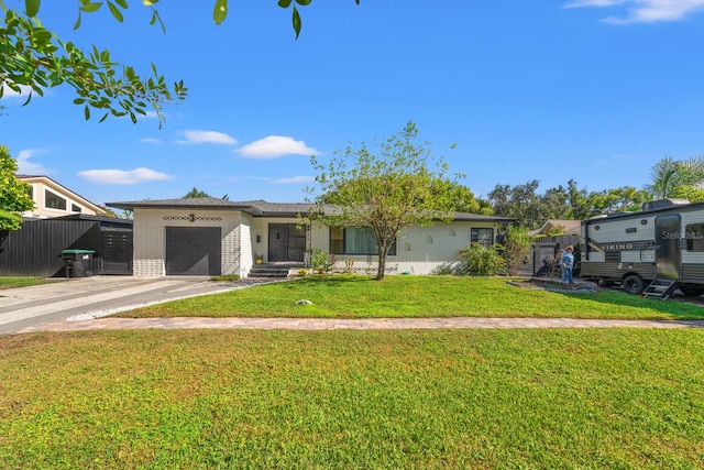 view of front of home with a garage and a front lawn