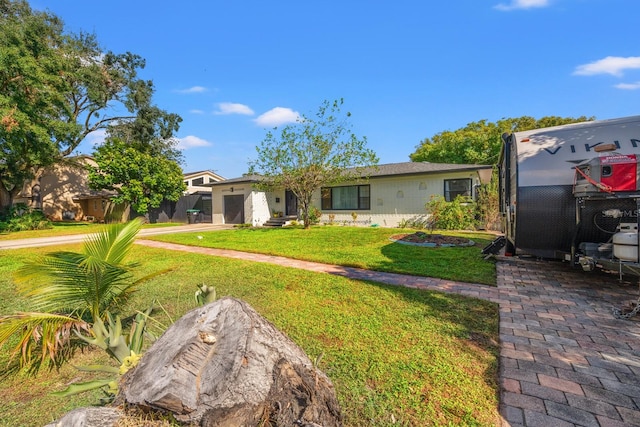 view of front of home featuring a garage and a front yard