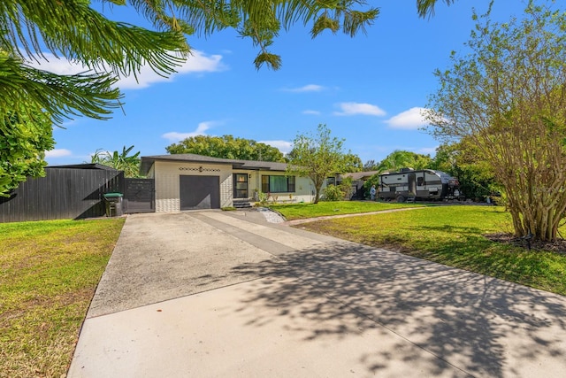 view of front of property featuring a garage and a front lawn