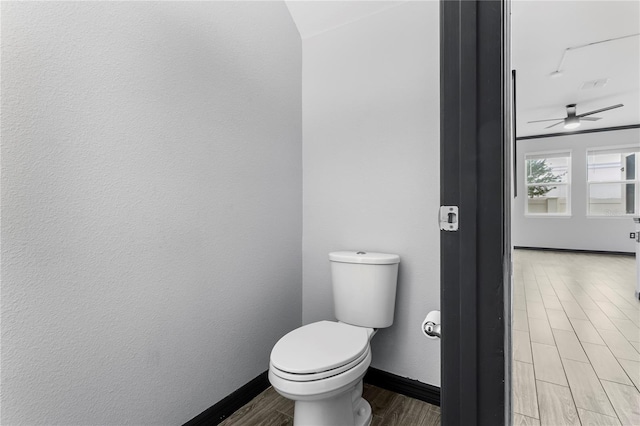 bathroom with ceiling fan and hardwood / wood-style floors