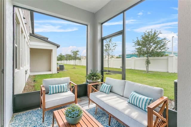 sunroom / solarium featuring a water view and a healthy amount of sunlight