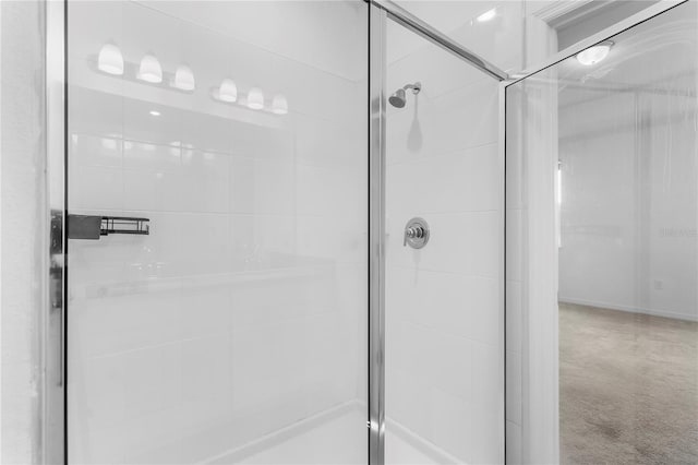 bathroom featuring a shower with door