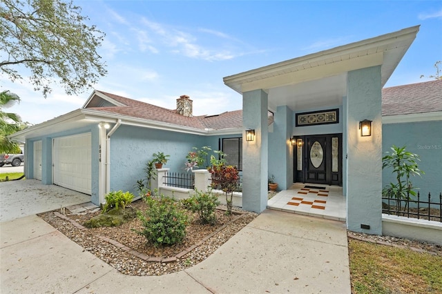 5016 Dorman Rd, Lakeland, FL 33813 - view of front facade with stucco siding, an attached garage, a chimney, driveway, and a shingled roof