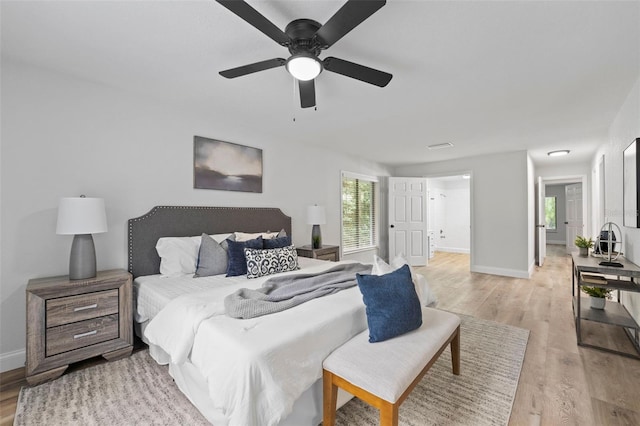 bedroom with ceiling fan and light hardwood / wood-style flooring