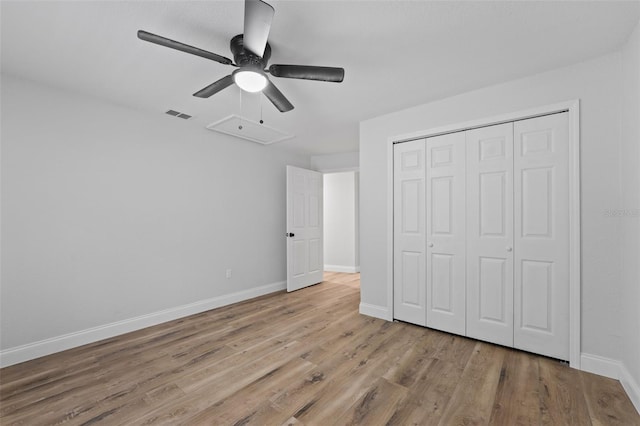 unfurnished bedroom featuring ceiling fan, a closet, and light hardwood / wood-style flooring