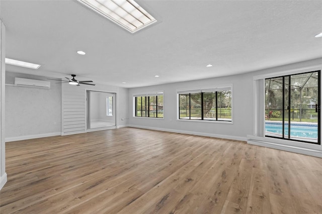 5016 Dorman Rd, Lakeland, FL 33813 - unfurnished living room with an AC wall unit, light wood finished floors, recessed lighting, and ceiling fan