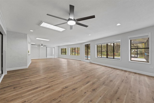 5016 Dorman Rd, Lakeland, FL 33813 - unfurnished living room featuring a ceiling fan, light wood-style floors, a textured ceiling, and recessed lighting