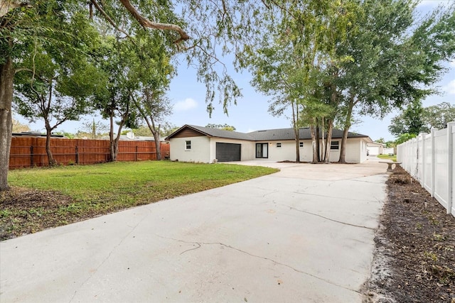 rear view of property featuring a lawn and a garage