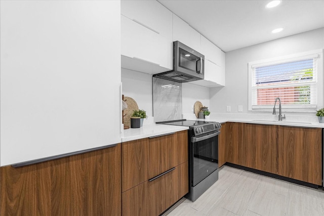 kitchen featuring white cabinetry, sink, and stainless steel appliances