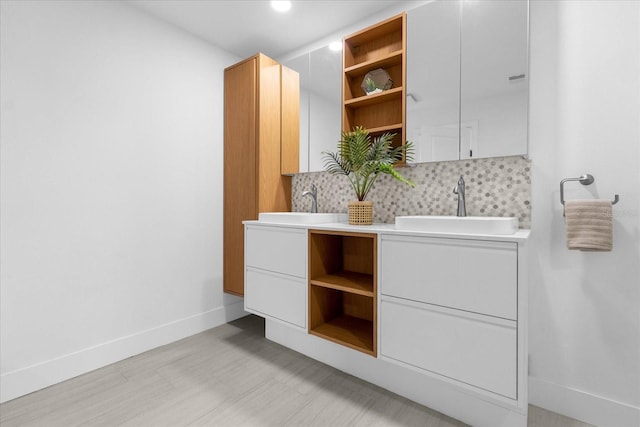 bathroom featuring decorative backsplash and vanity