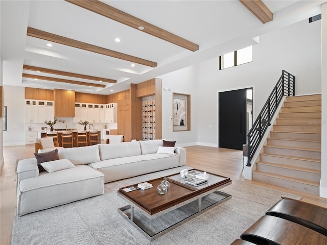 living room featuring beamed ceiling