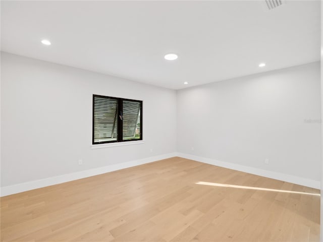 spare room featuring light hardwood / wood-style floors