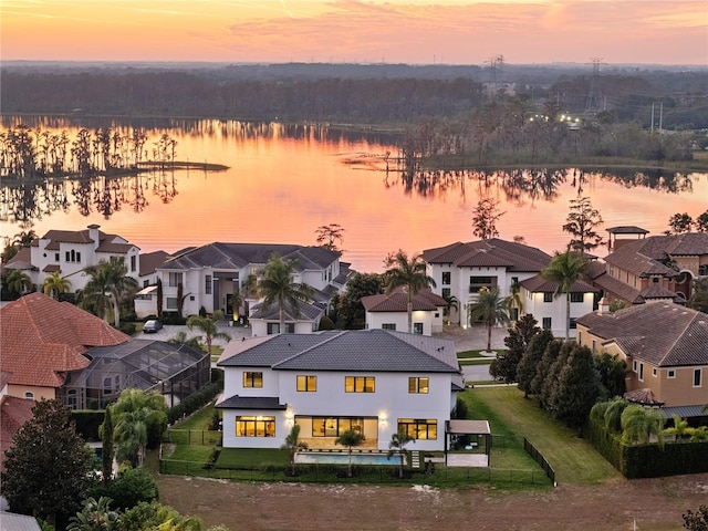 aerial view at dusk with a water view