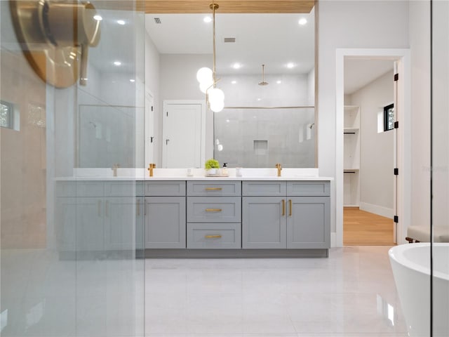 bathroom featuring separate shower and tub and vanity