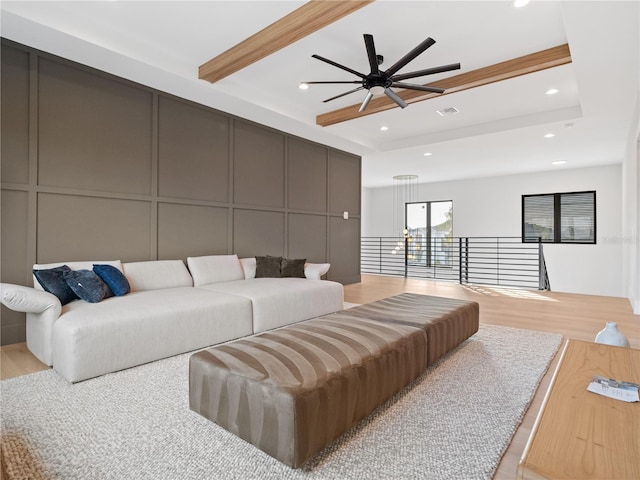 living room with ceiling fan and light hardwood / wood-style flooring