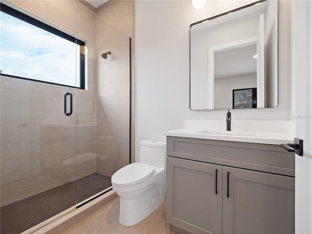 bathroom featuring toilet, a shower with door, and vanity