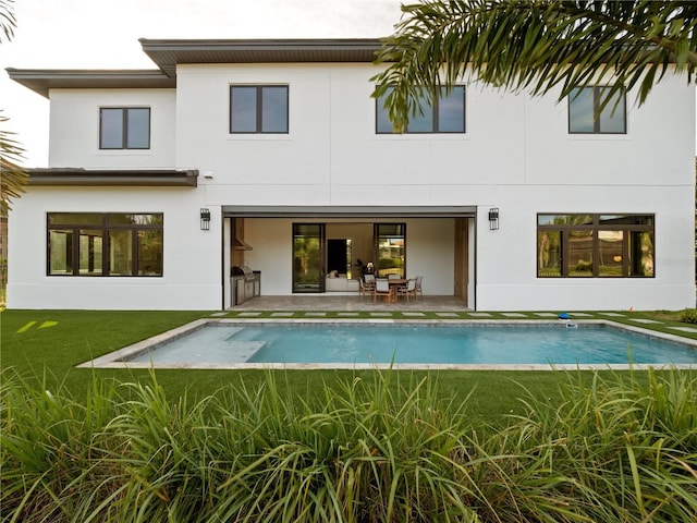 rear view of property with a patio area and a lawn