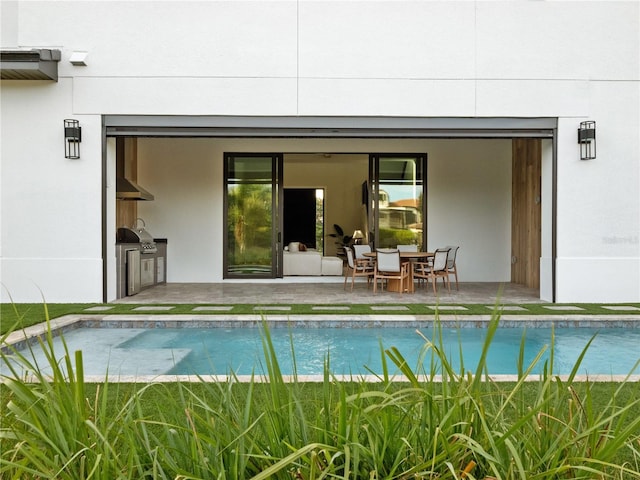 view of swimming pool with area for grilling and a patio