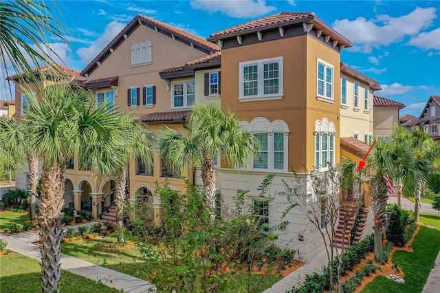 mediterranean / spanish-style house featuring a front lawn