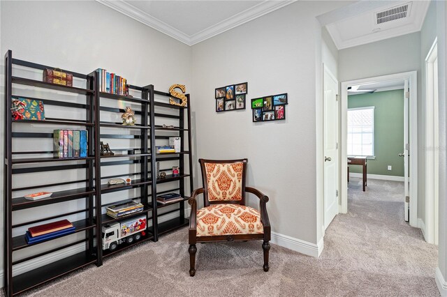 sitting room featuring carpet flooring and ornamental molding