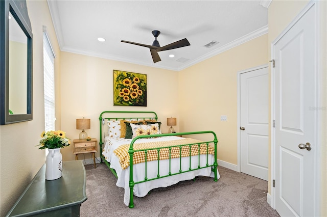 carpeted bedroom with ceiling fan and ornamental molding