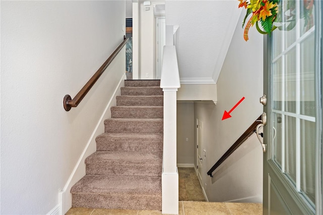 stairway featuring crown molding