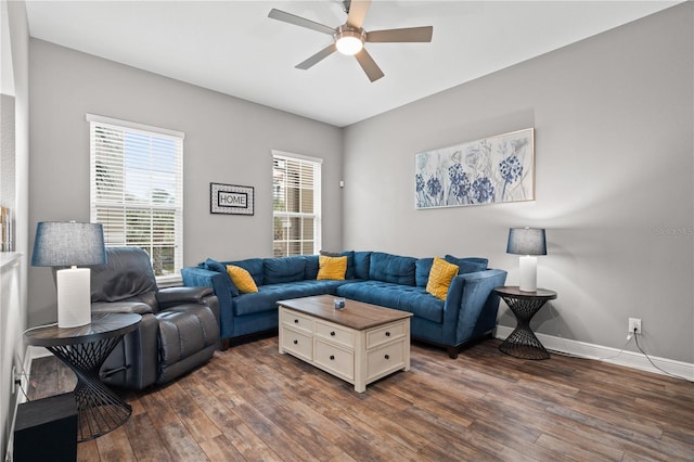 living room featuring dark wood-style flooring, a ceiling fan, and baseboards