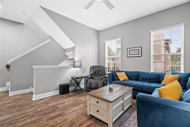 living room with dark wood-type flooring, baseboards, and a ceiling fan