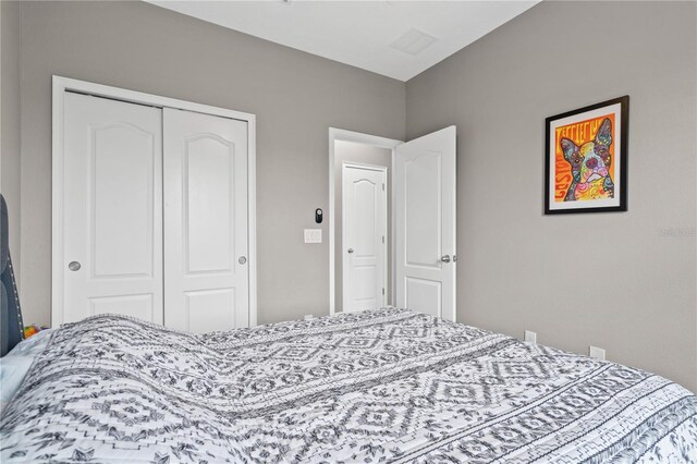 bedroom featuring a closet and visible vents